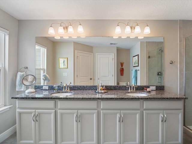 bathroom featuring an enclosed shower and vanity