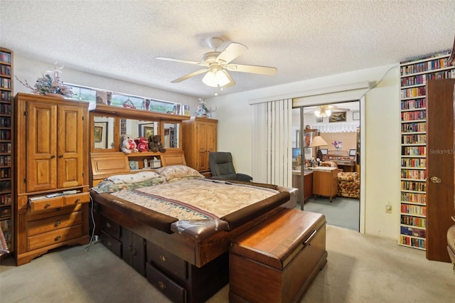 carpeted bedroom with ceiling fan and a textured ceiling