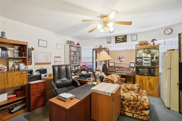 office featuring a textured ceiling, ceiling fan, and carpet