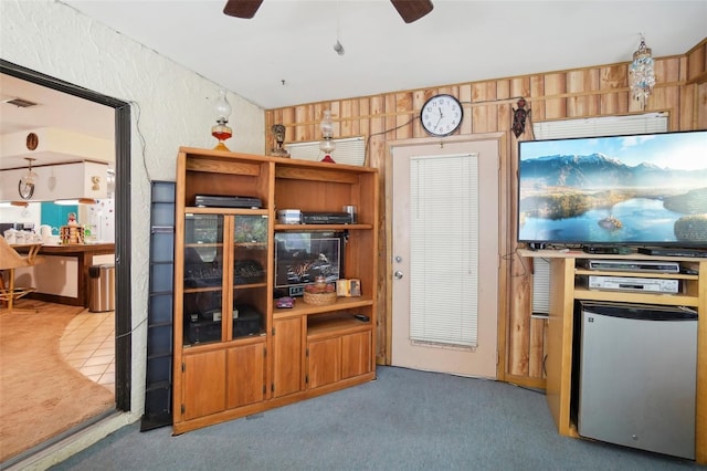 interior space with stainless steel refrigerator, ceiling fan, and light carpet