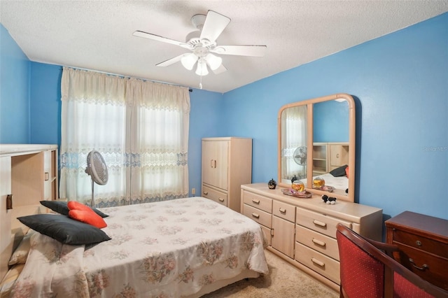 carpeted bedroom with ceiling fan and a textured ceiling