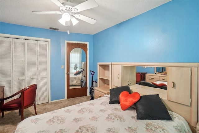 bedroom with light carpet, a closet, and ceiling fan