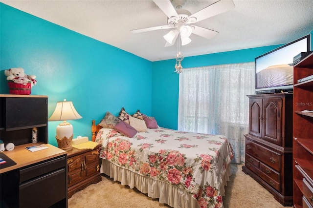 carpeted bedroom with a textured ceiling and ceiling fan