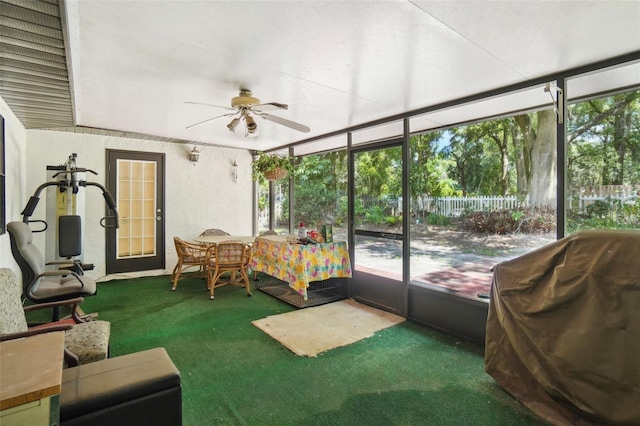 sunroom / solarium featuring ceiling fan