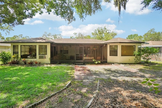 rear view of house featuring a yard