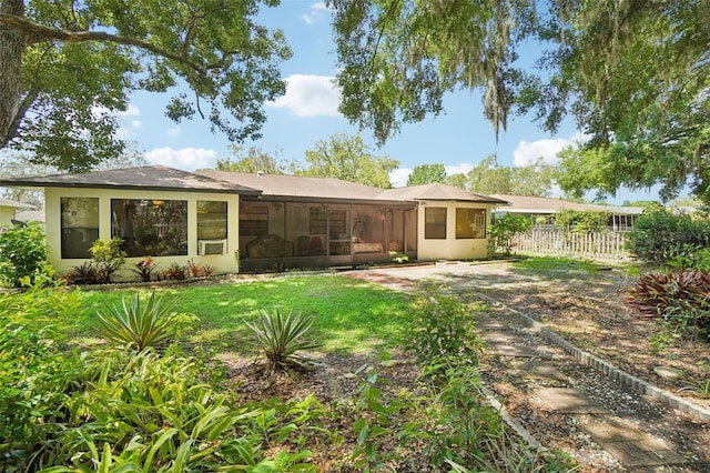 rear view of house featuring a yard