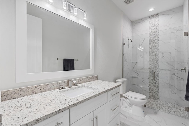 bathroom with vanity, toilet, and a shower with shower door