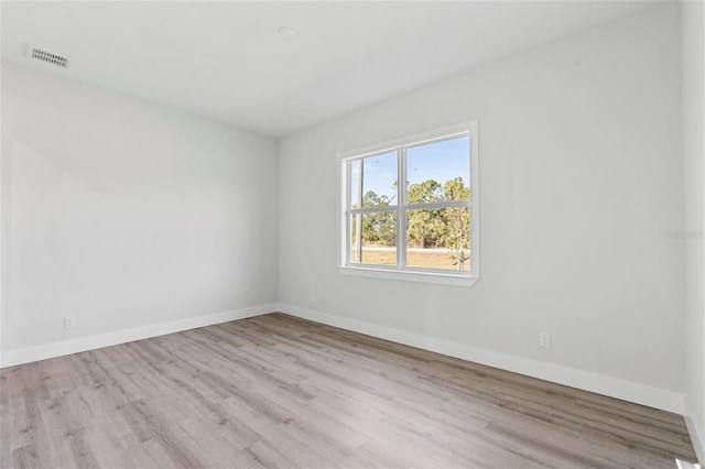 unfurnished room with light hardwood / wood-style floors