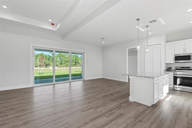 kitchen with light hardwood / wood-style flooring, appliances with stainless steel finishes, a center island, white cabinets, and decorative light fixtures