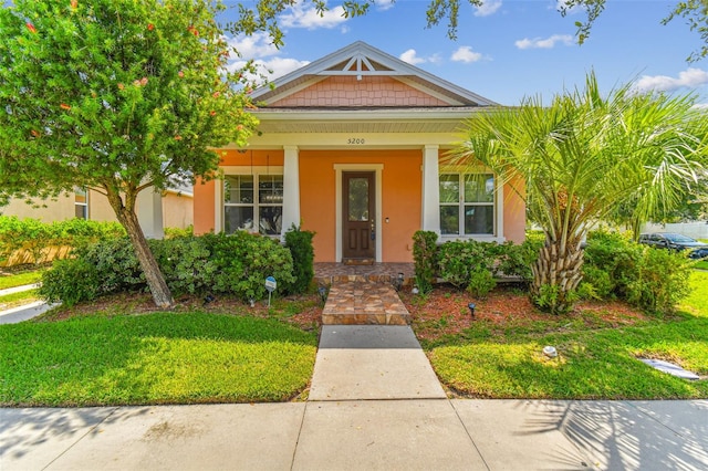 view of front of home featuring a front lawn and a porch