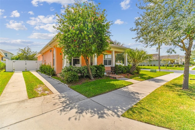 obstructed view of property with a front lawn