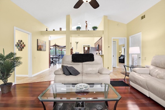 living room featuring hardwood / wood-style floors, vaulted ceiling, and ceiling fan