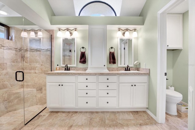 bathroom with vanity, toilet, a shower with shower door, and vaulted ceiling