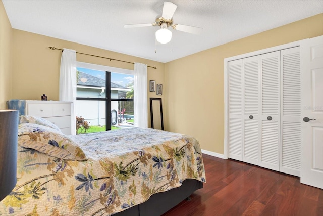 bedroom with a textured ceiling, dark wood-type flooring, a closet, and ceiling fan