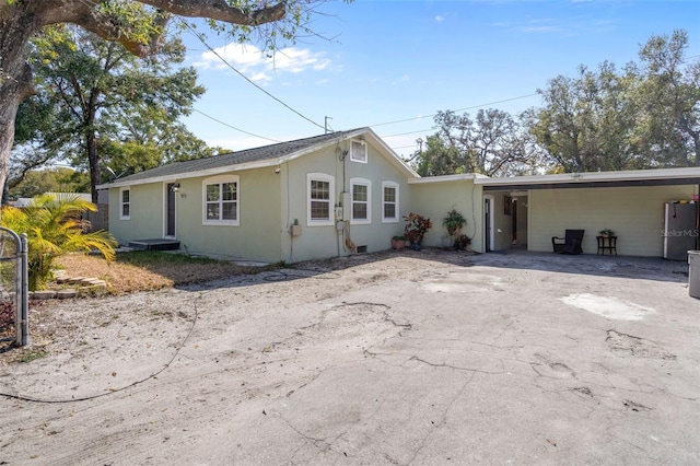 ranch-style home featuring a carport