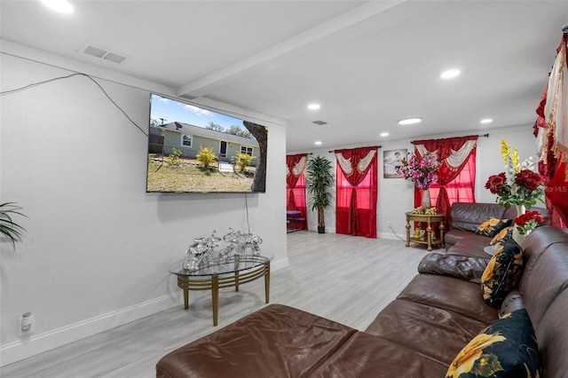 living room featuring hardwood / wood-style flooring and beam ceiling