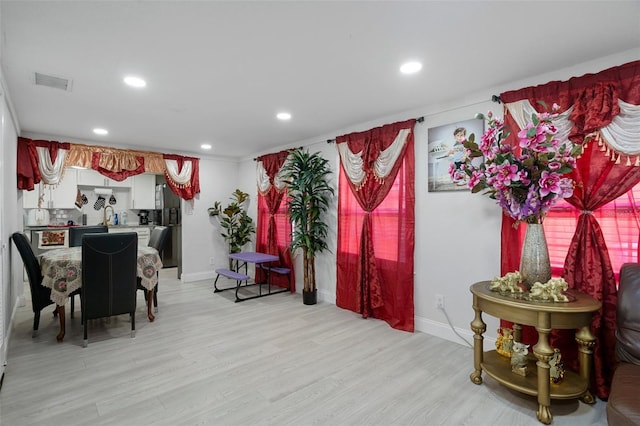 dining room with light hardwood / wood-style flooring