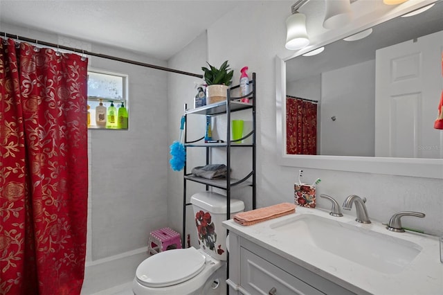 bathroom with vanity, toilet, and walk in shower