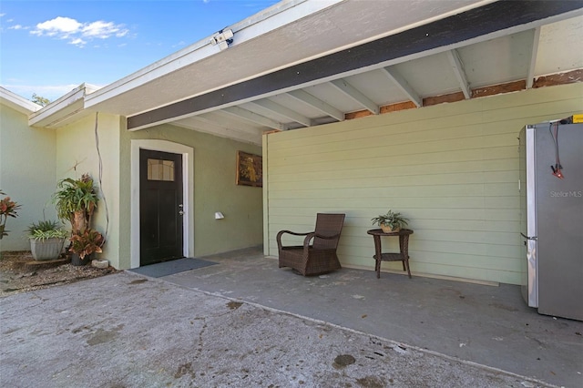 doorway to property featuring a patio area