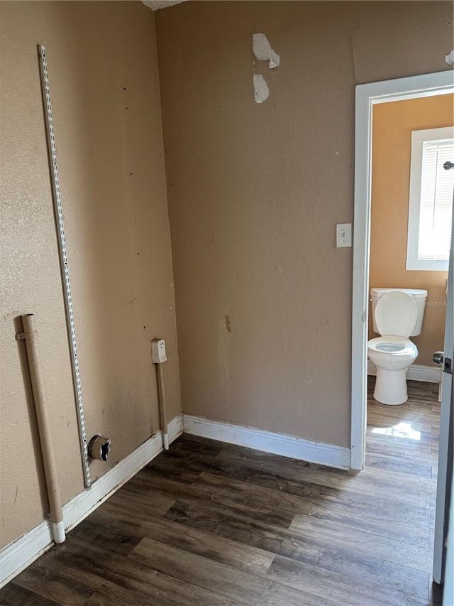 washroom with dark wood-style floors and baseboards