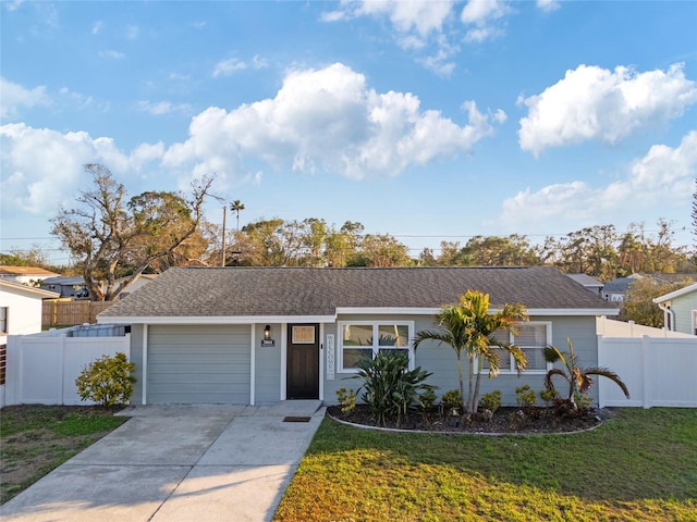 ranch-style home with a garage and a front lawn