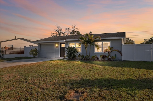 ranch-style house with a garage and a lawn