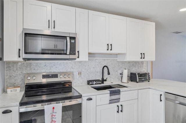 kitchen featuring stainless steel appliances and white cabinets