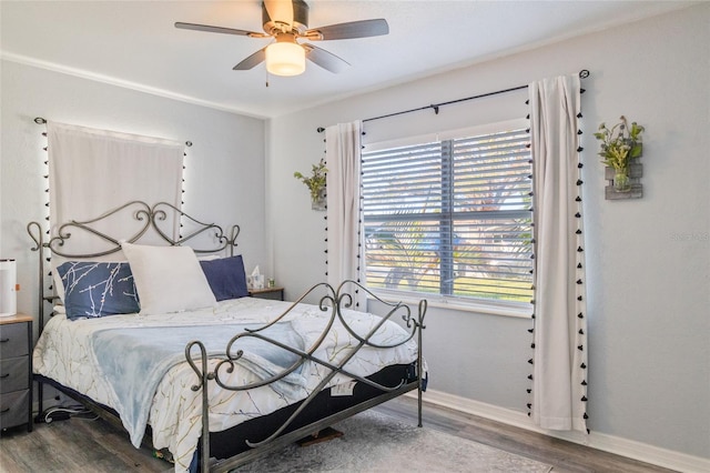 bedroom with wood-type flooring and ceiling fan