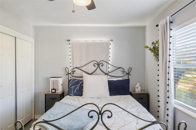 bedroom with ceiling fan and a closet