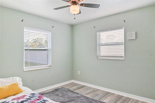 unfurnished bedroom with ceiling fan and hardwood / wood-style floors