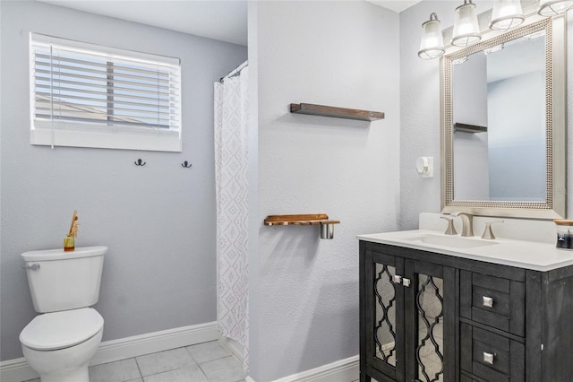 bathroom with tile patterned flooring, vanity, and toilet