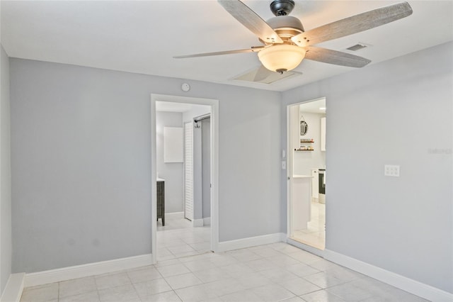 unfurnished room featuring ceiling fan and light tile patterned flooring