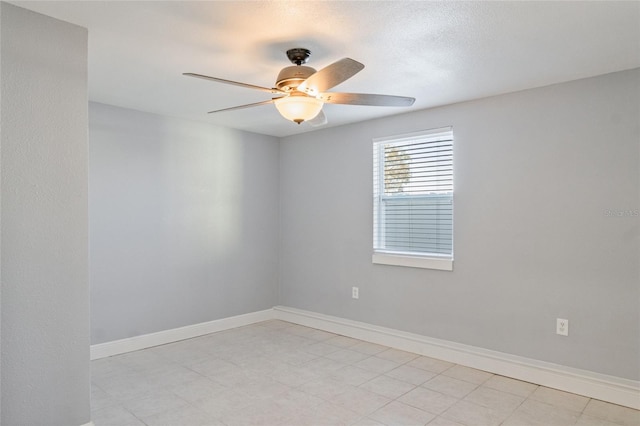 empty room with a textured ceiling and ceiling fan