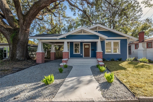 craftsman-style house with covered porch and a front lawn