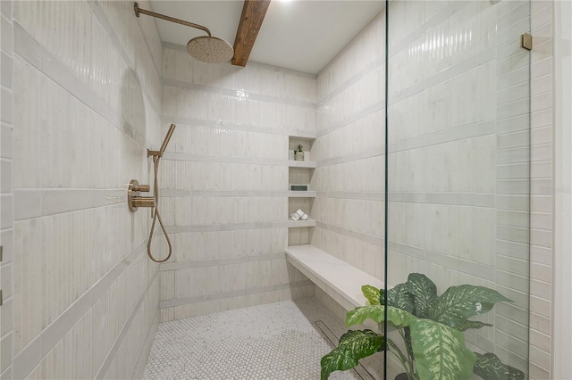 bathroom featuring tiled shower and beam ceiling