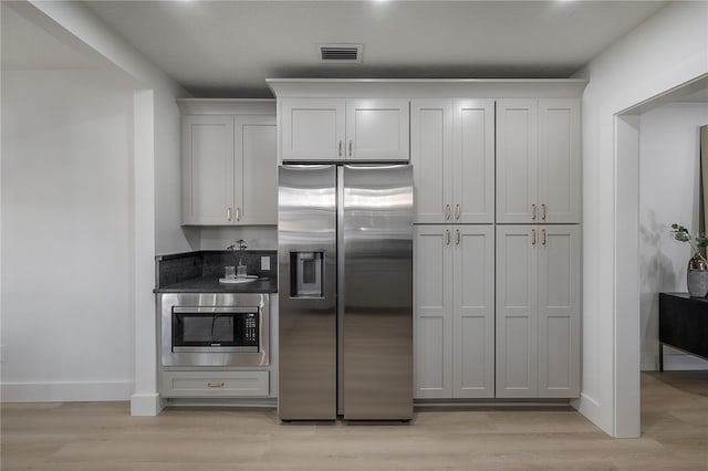 kitchen featuring white cabinetry, appliances with stainless steel finishes, and light hardwood / wood-style flooring