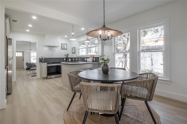 dining space featuring plenty of natural light and light wood-type flooring