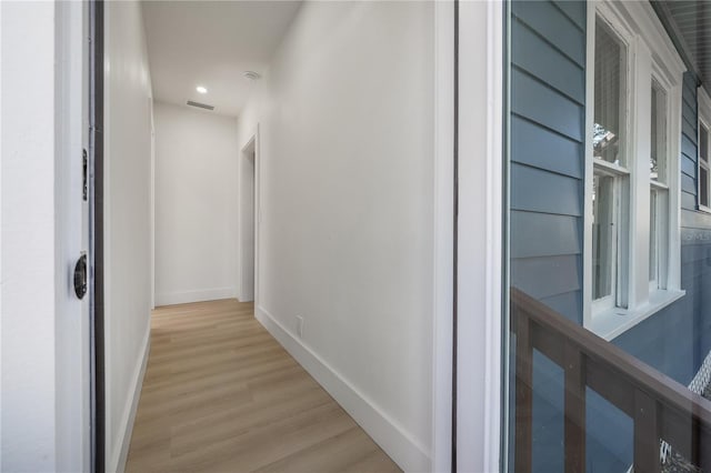 hallway with light hardwood / wood-style floors