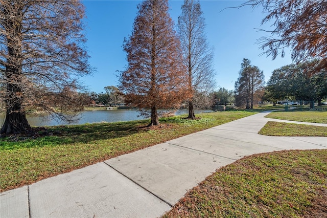 view of community featuring a water view and a lawn