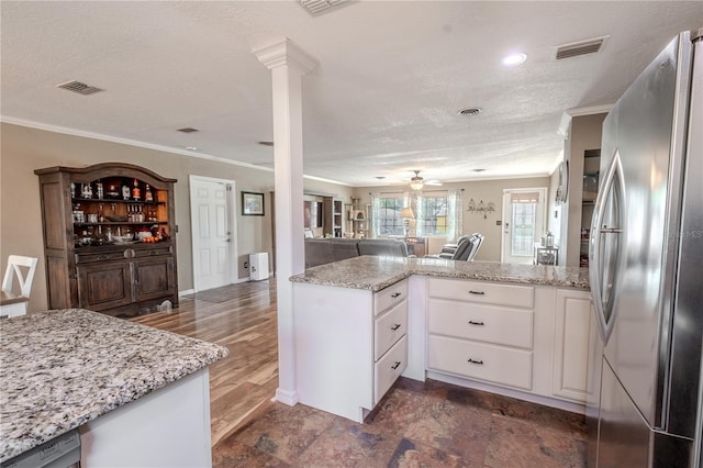 kitchen with white cabinetry, crown molding, light stone counters, kitchen peninsula, and stainless steel appliances