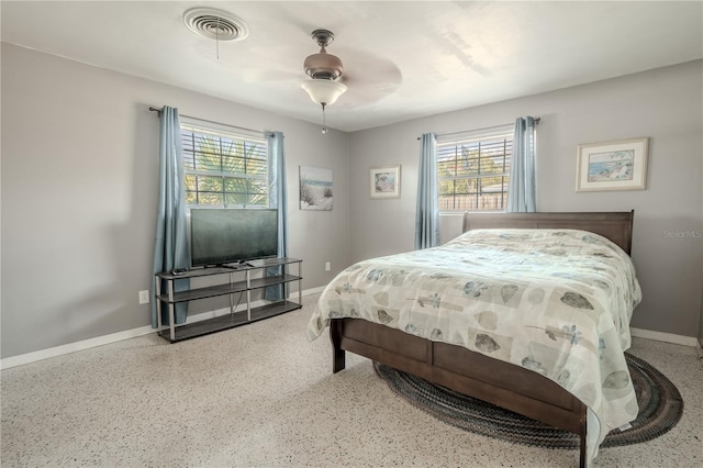 bedroom with multiple windows and ceiling fan