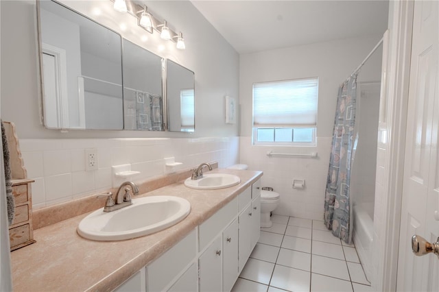 full bathroom featuring tile patterned floors, toilet, tile walls, vanity, and shower / bath combo