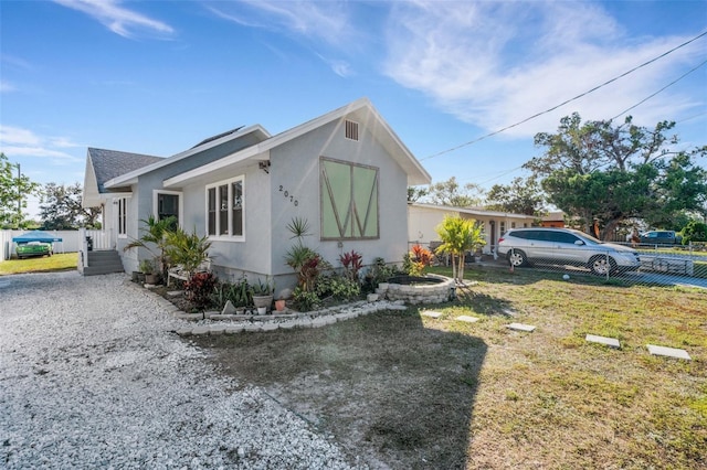 view of side of home with a lawn