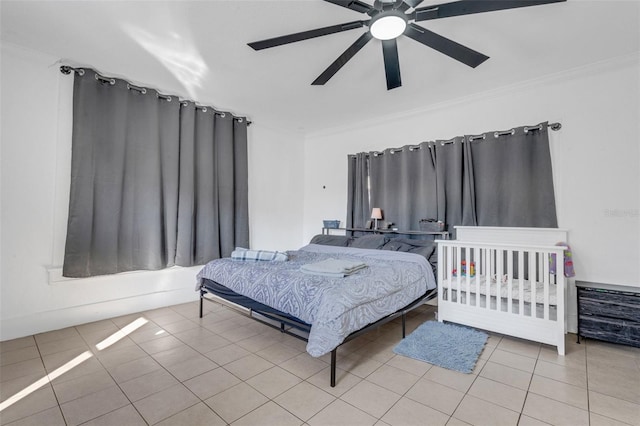 tiled bedroom with crown molding and ceiling fan