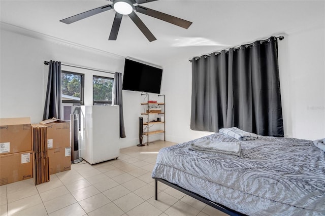 tiled bedroom with crown molding and ceiling fan