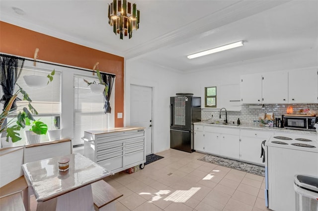 kitchen featuring black refrigerator, sink, white cabinetry, and white electric stove