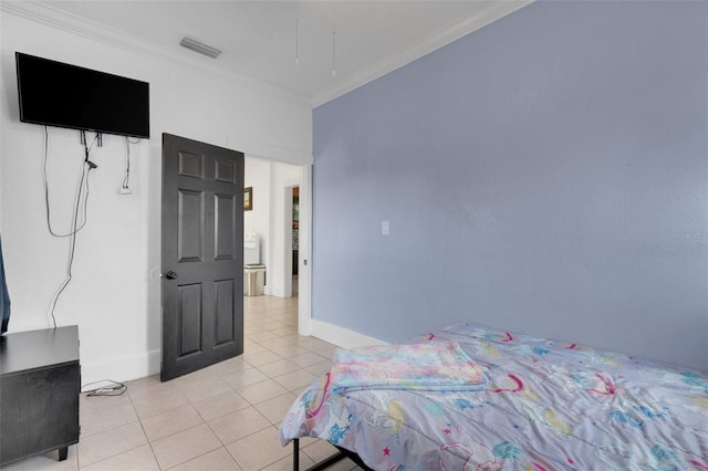 bedroom with ornamental molding and light tile patterned floors