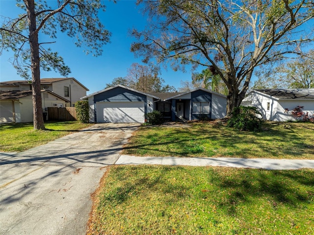 single story home with a garage and a front lawn