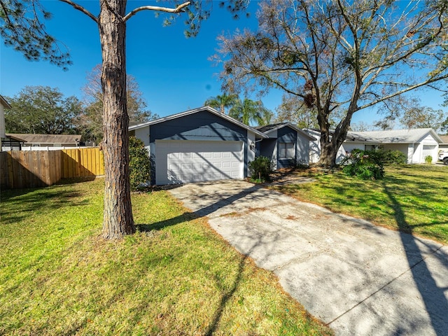 ranch-style home with a garage and a front yard