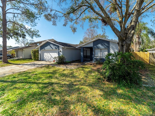 ranch-style house with a garage and a front lawn